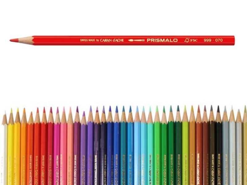Red Prismalo colored pencil floating above a rainbow row of sharpened pencils arranged by color.